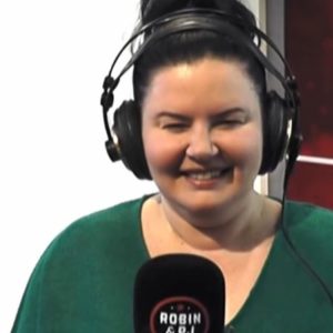 Robin walks around her building pre-dawn in her [BLANK]!